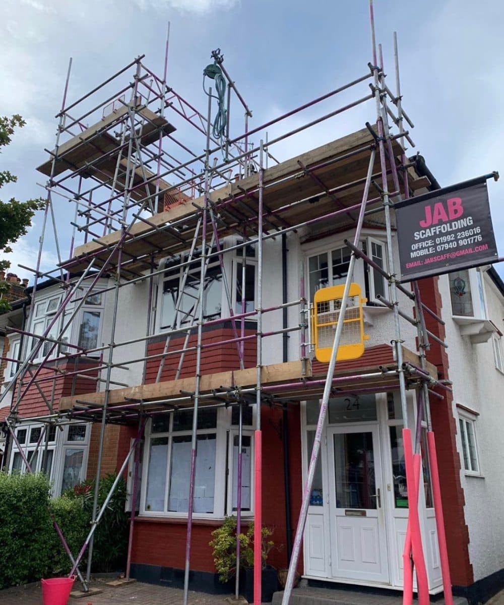 Scaffolding structure surrounding a residential building under refurbishment